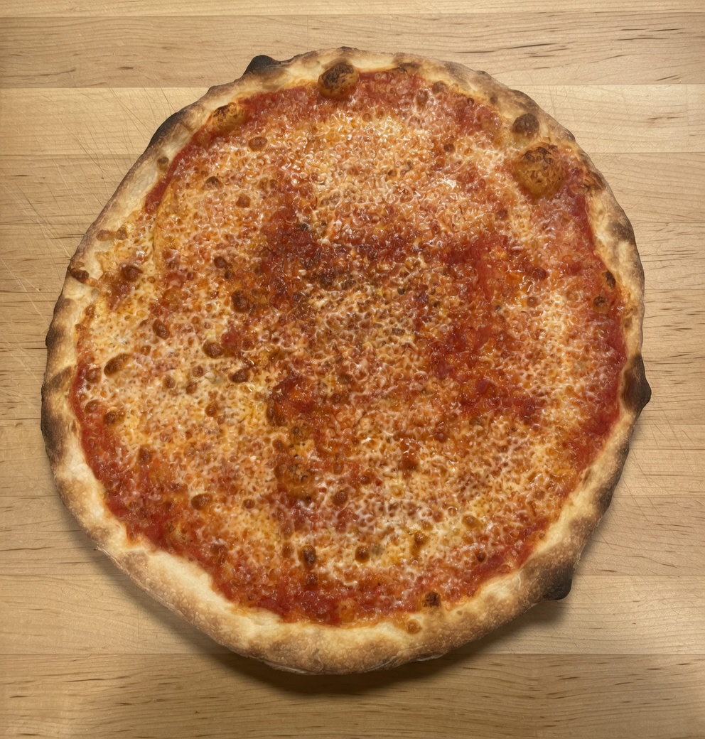 Classic cheese pizza with melted mozzarella on our house tomato sauce